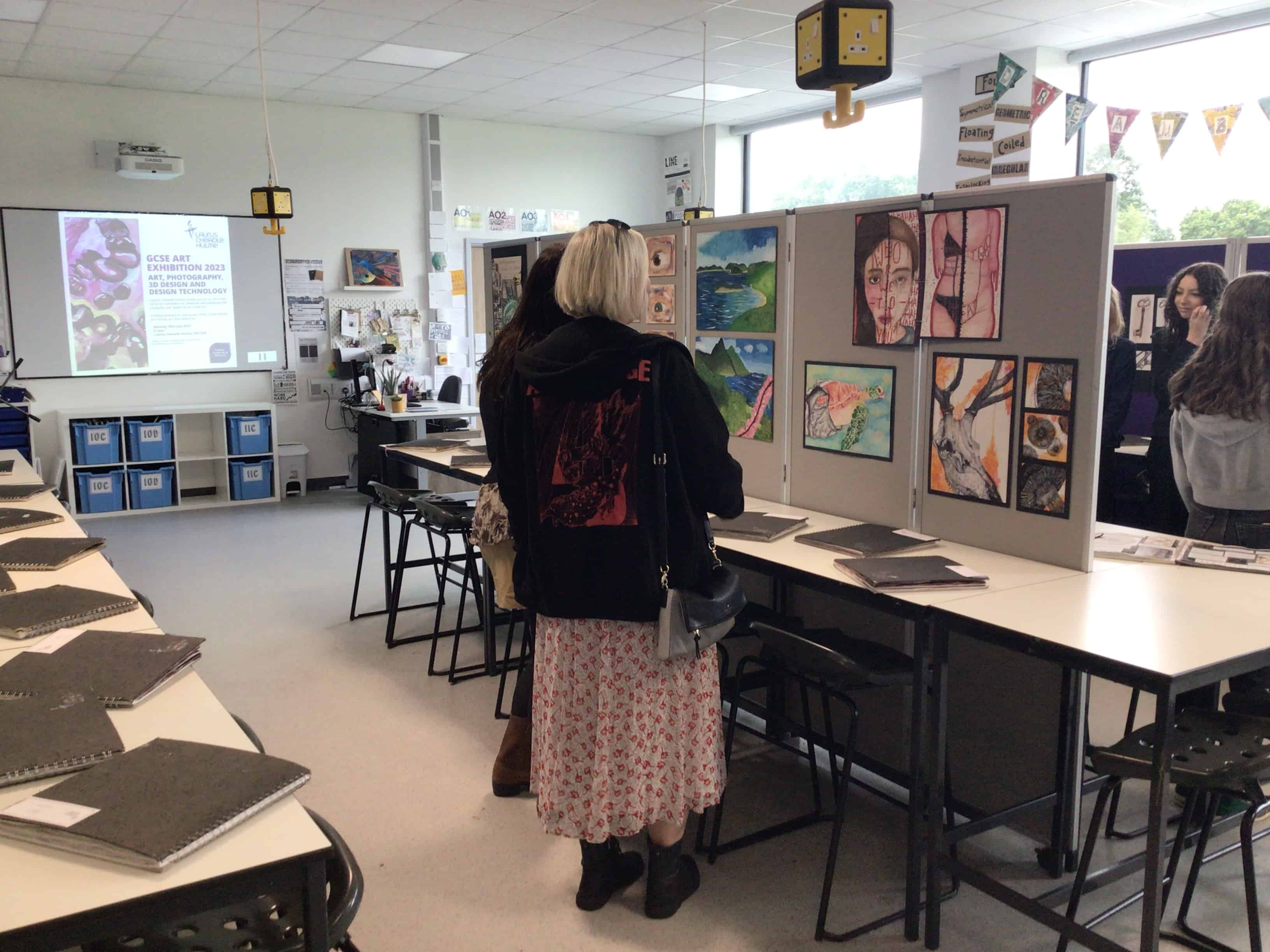 People view GCSE art at the Laurus Cheadle Hulme Art Exhibition 2023