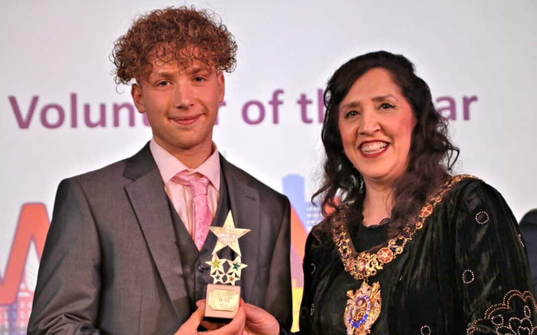 Kiva from Laurus Cheadle Hulme holds his Spirit of Manchester Award with the Lord Mayor of Manchester.