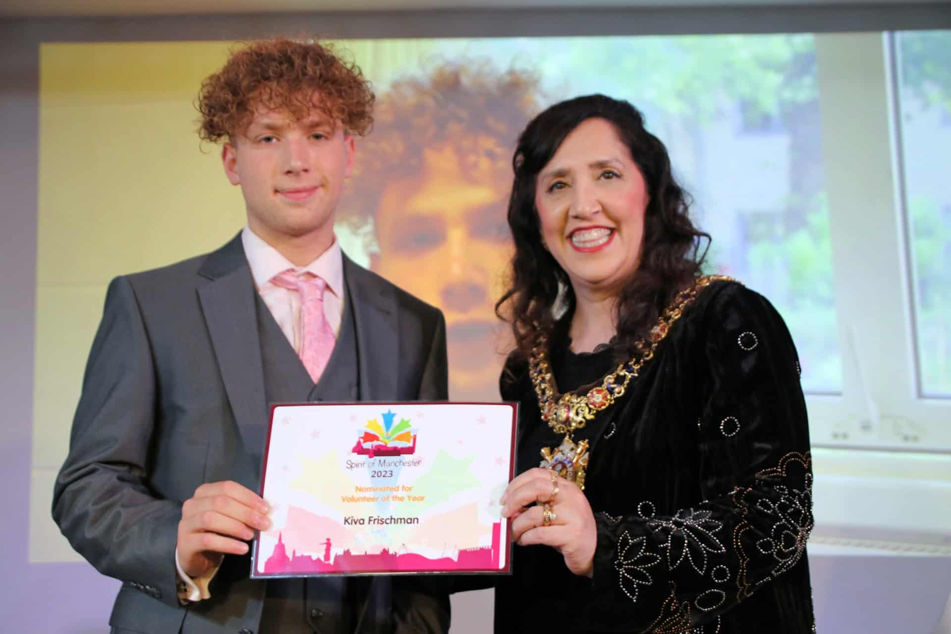 Kiva from Laurus Cheadle Hulme holds his Spirit of Manchester Award with the Lord Mayor of Manchester.