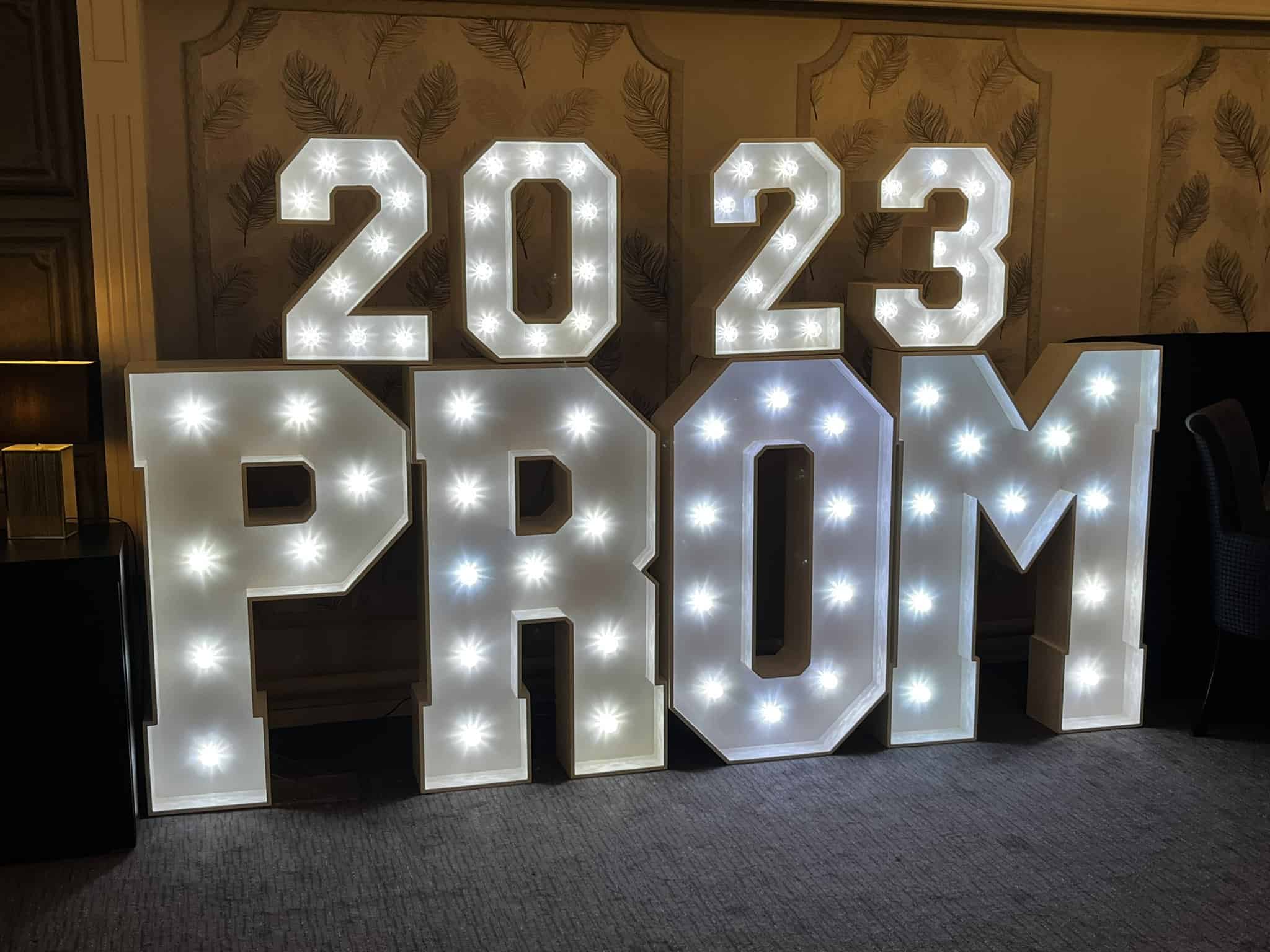 A sign made of lights says 2023 PROM, at the first ever Laurus Cheadle Hulme prom