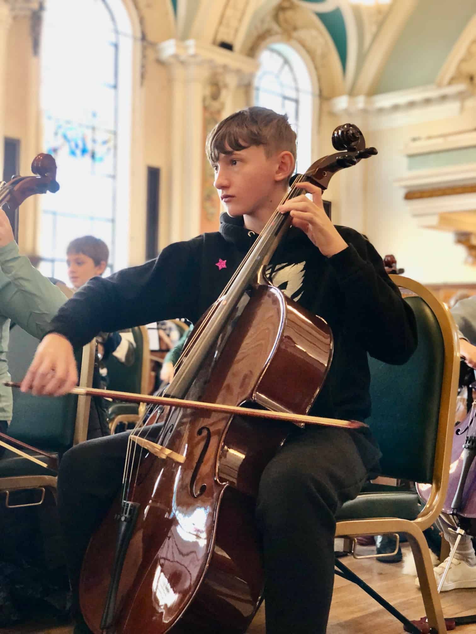 A student from Laurus Cheadle Hulme plays a string instrument at the Benedetti Strings day at Stockport Town Hall.