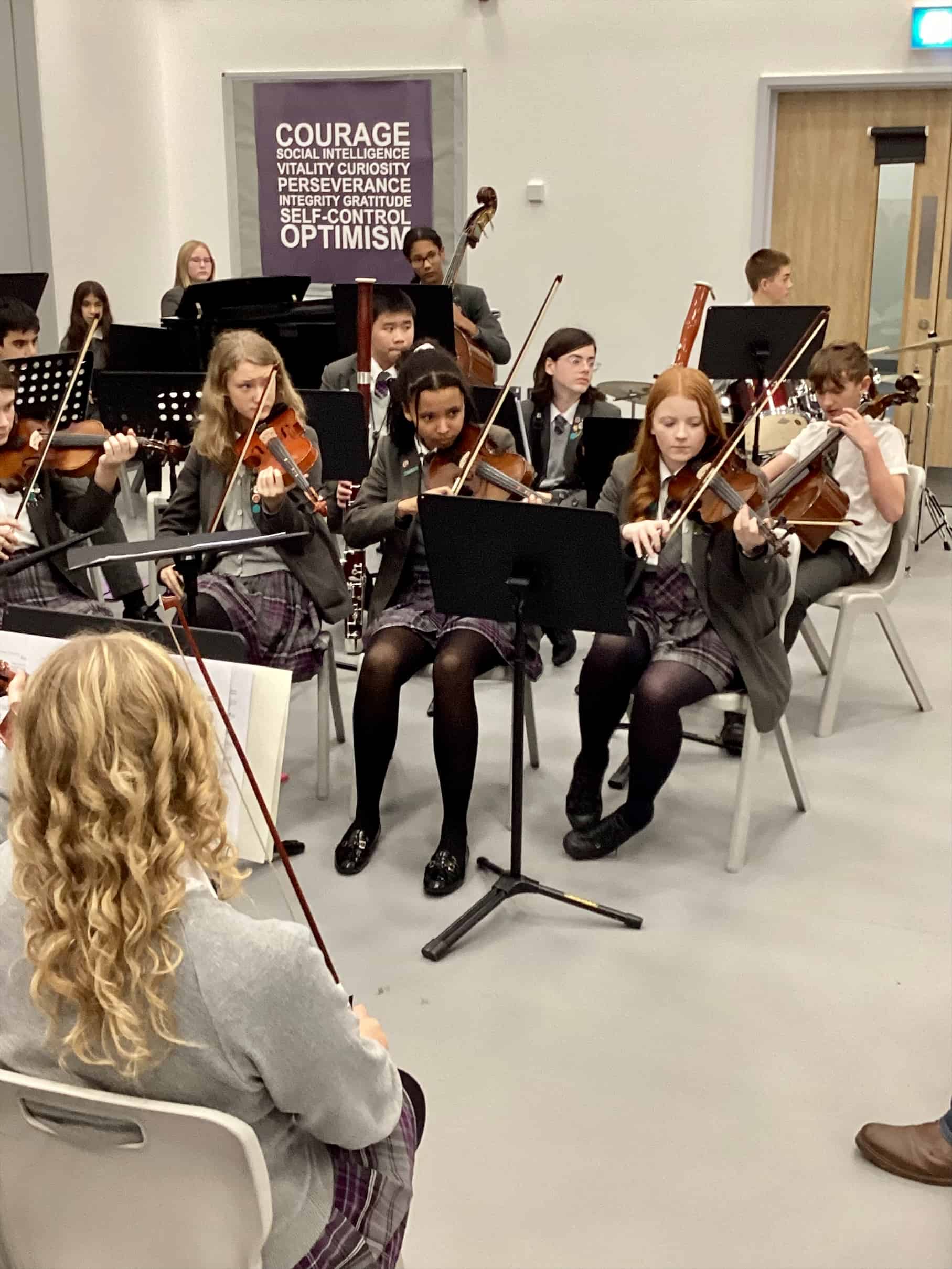 Students from the Laurus Cheadle Hulme Orchestra play their instruments during a workshop with David Hext.